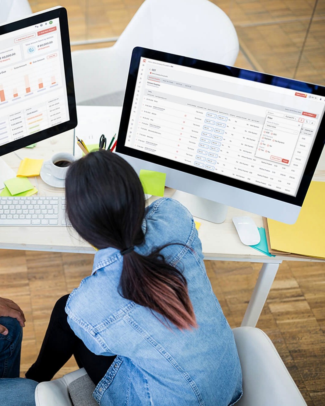 A Finac team member working through the GST screen with a client's dashboard on the second monitor